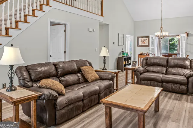 a living room with furniture and wooden floor