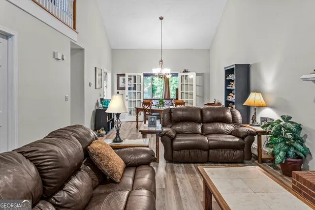 a living room with furniture and a chandelier