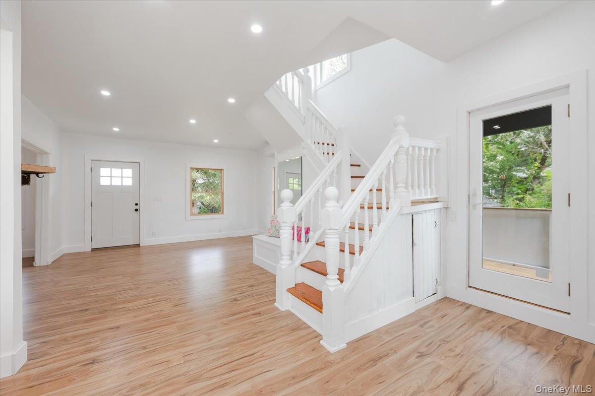56 Oak Beach Road Babylon, NY 11702 - Photo 16 of 30 View from Kitchen into dining area and to original staircase with refinished wide plank hardwood stairs.