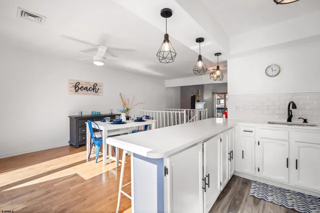 a kitchen with a sink cabinets and wooden floor