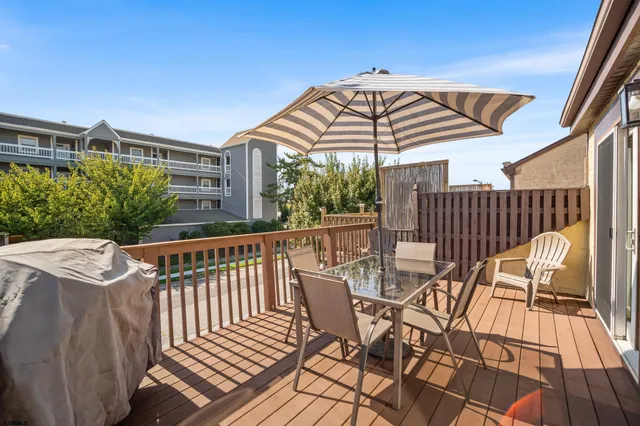 a view of balcony with furniture and umbrella