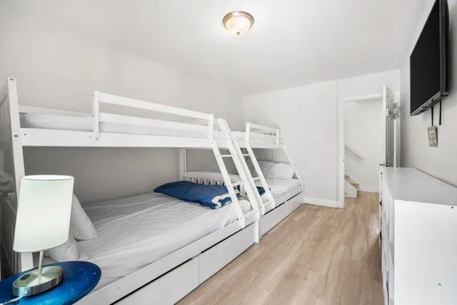 a bed room with a bed and a flat screen tv