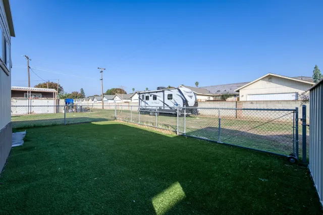 a view of a backyard with sitting area