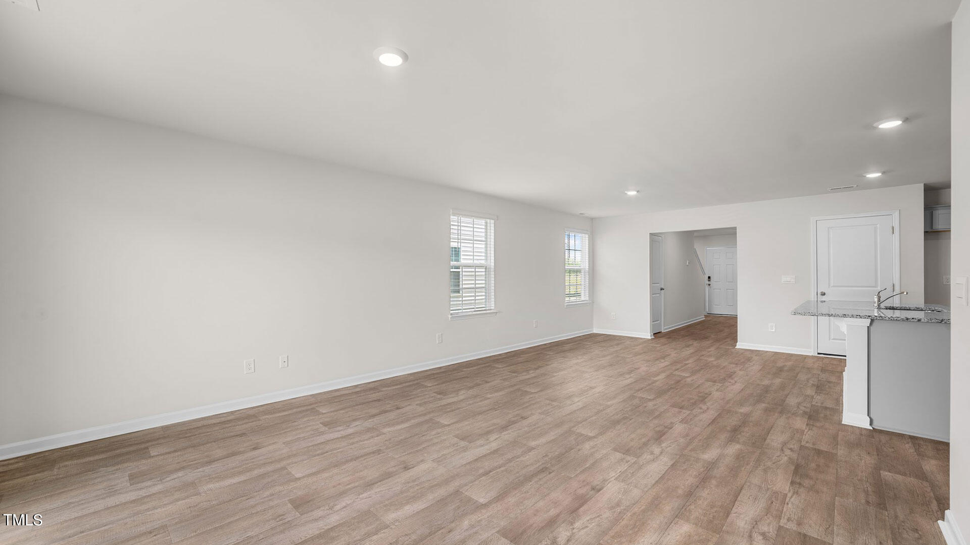 210 River Bank Road Fuquay-Varina, NC 27526 - Photo 19 of 36 a view of an empty room with wooden floor and a window