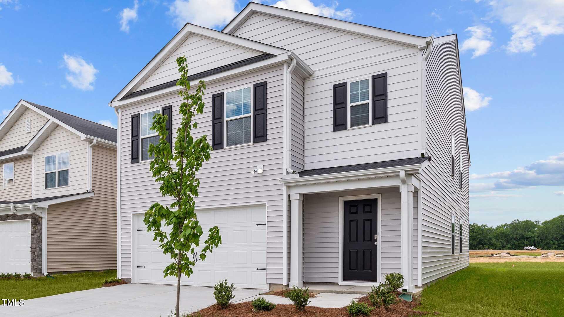 210 River Bank Road Fuquay-Varina, NC 27526 - Photo 33 of 36 a front view of a house with a yard