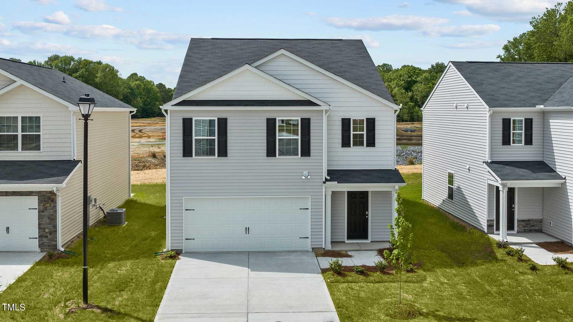210 River Bank Road Fuquay-Varina, NC 27526 - Photo 4 of 36 a view of a house with a yard