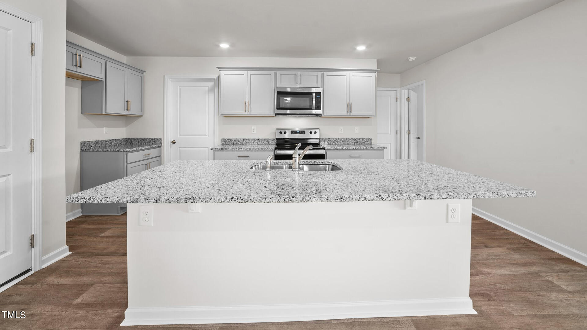 210 River Bank Road Fuquay-Varina, NC 27526 - Photo 5 of 36 a kitchen with granite countertop a sink a stove and a refrigerator