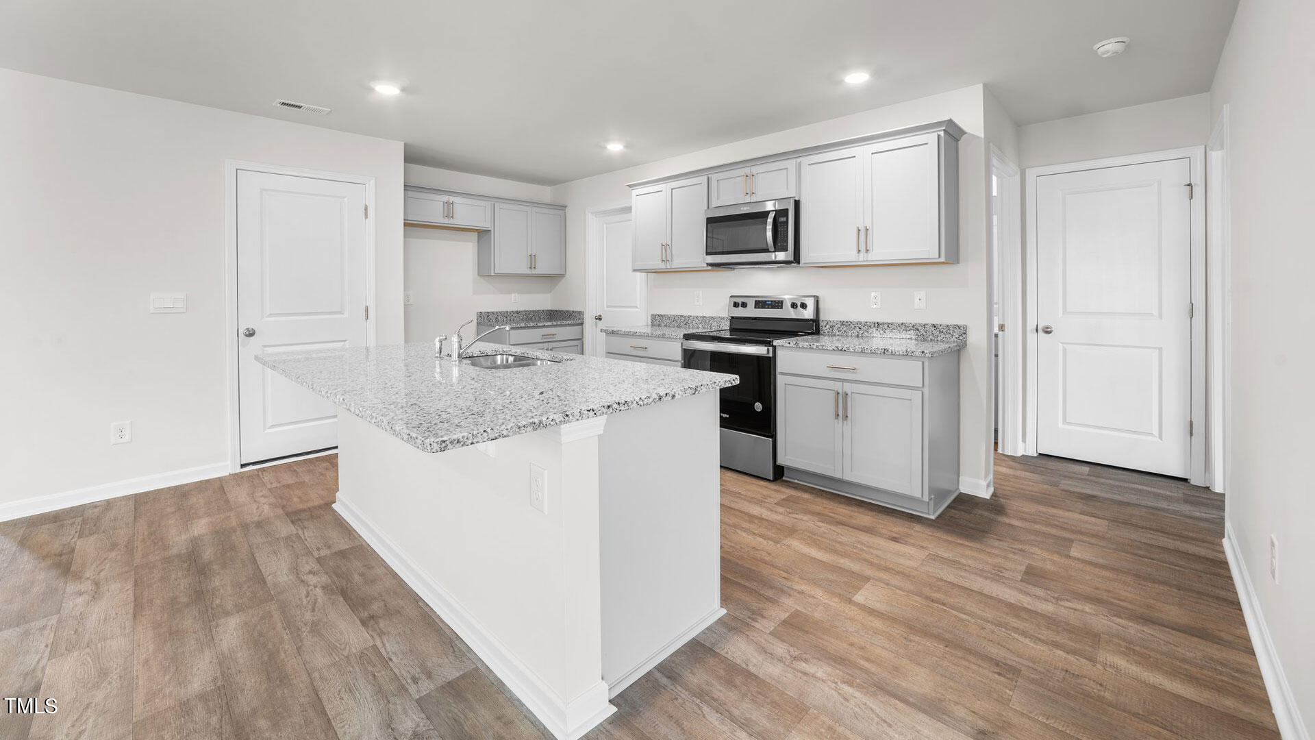 210 River Bank Road Fuquay-Varina, NC 27526 - Photo 8 of 36 a kitchen with stainless steel appliances granite countertop a stove top oven a sink dishwasher and a refrigerator with wooden floor