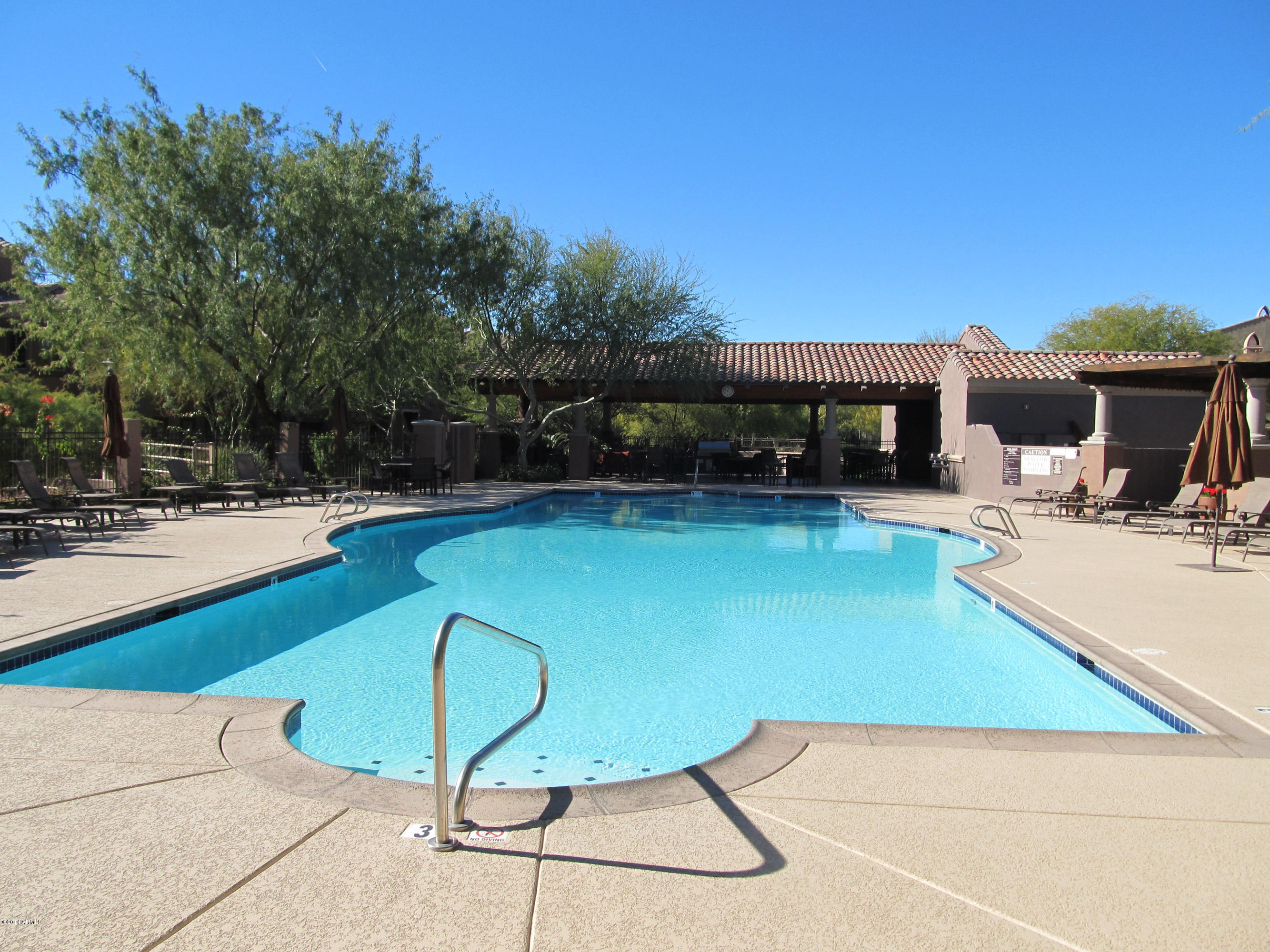 3935 East Rough Rider Road, Unit 1358 Phoenix, AZ 85050 - Photo 15 of 15 a swimming pool with outdoor seating and yard