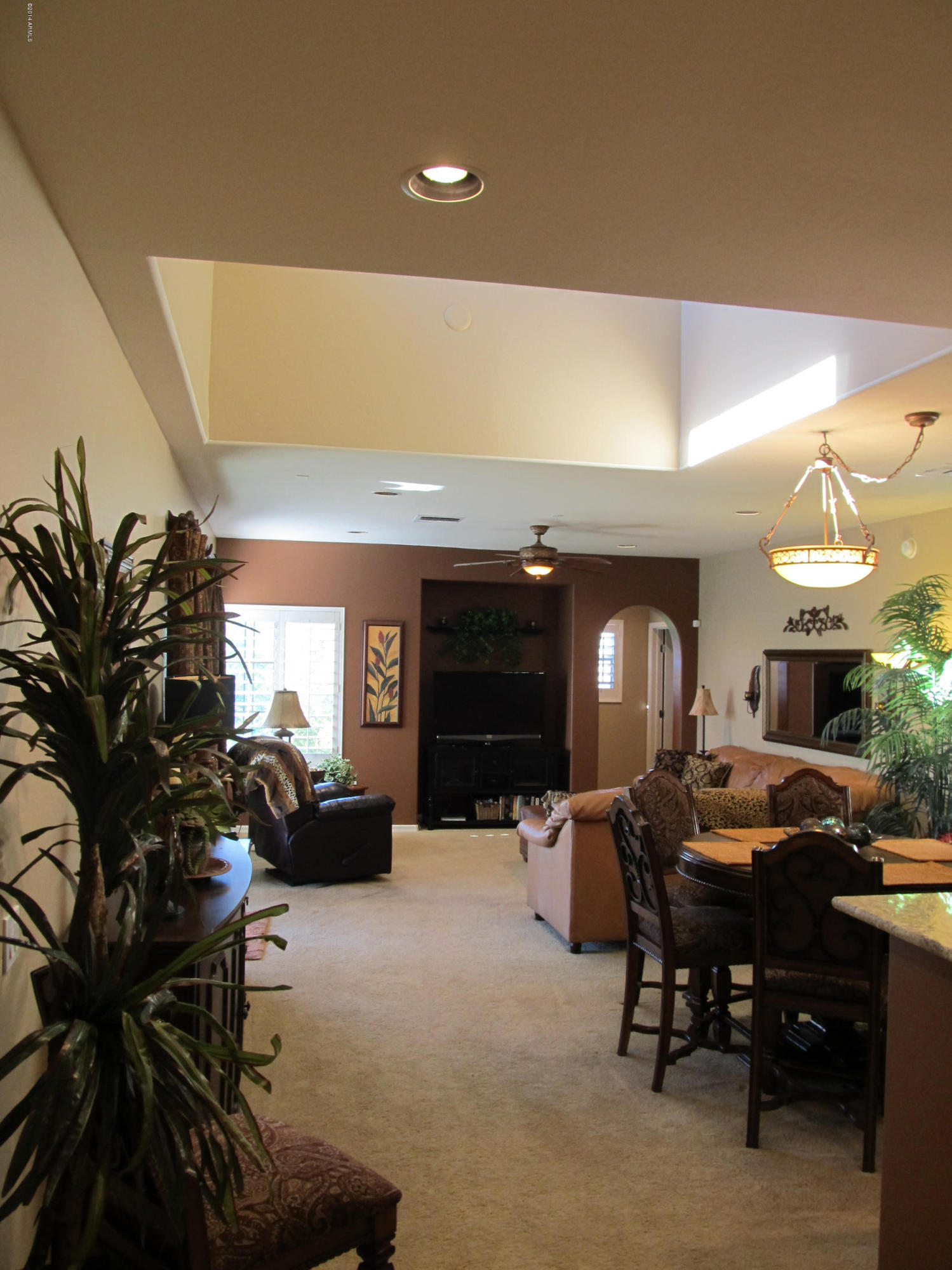 3935 East Rough Rider Road, Unit 1358 Phoenix, AZ 85050 - Photo 3 of 15 a living room with furniture and a potted plant