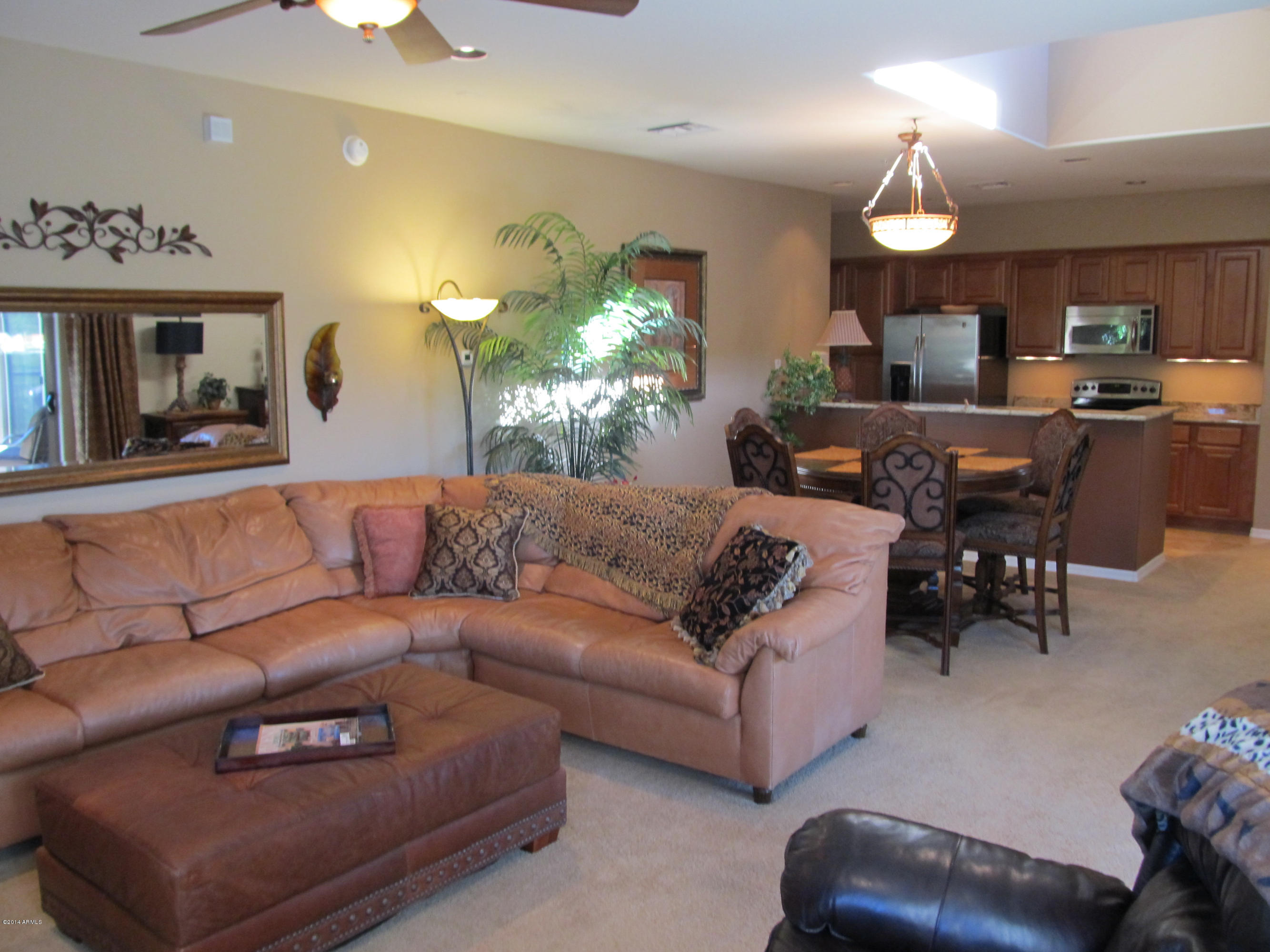 3935 East Rough Rider Road, Unit 1358 Phoenix, AZ 85050 - Photo 4 of 15 a living room with furniture and a chandelier