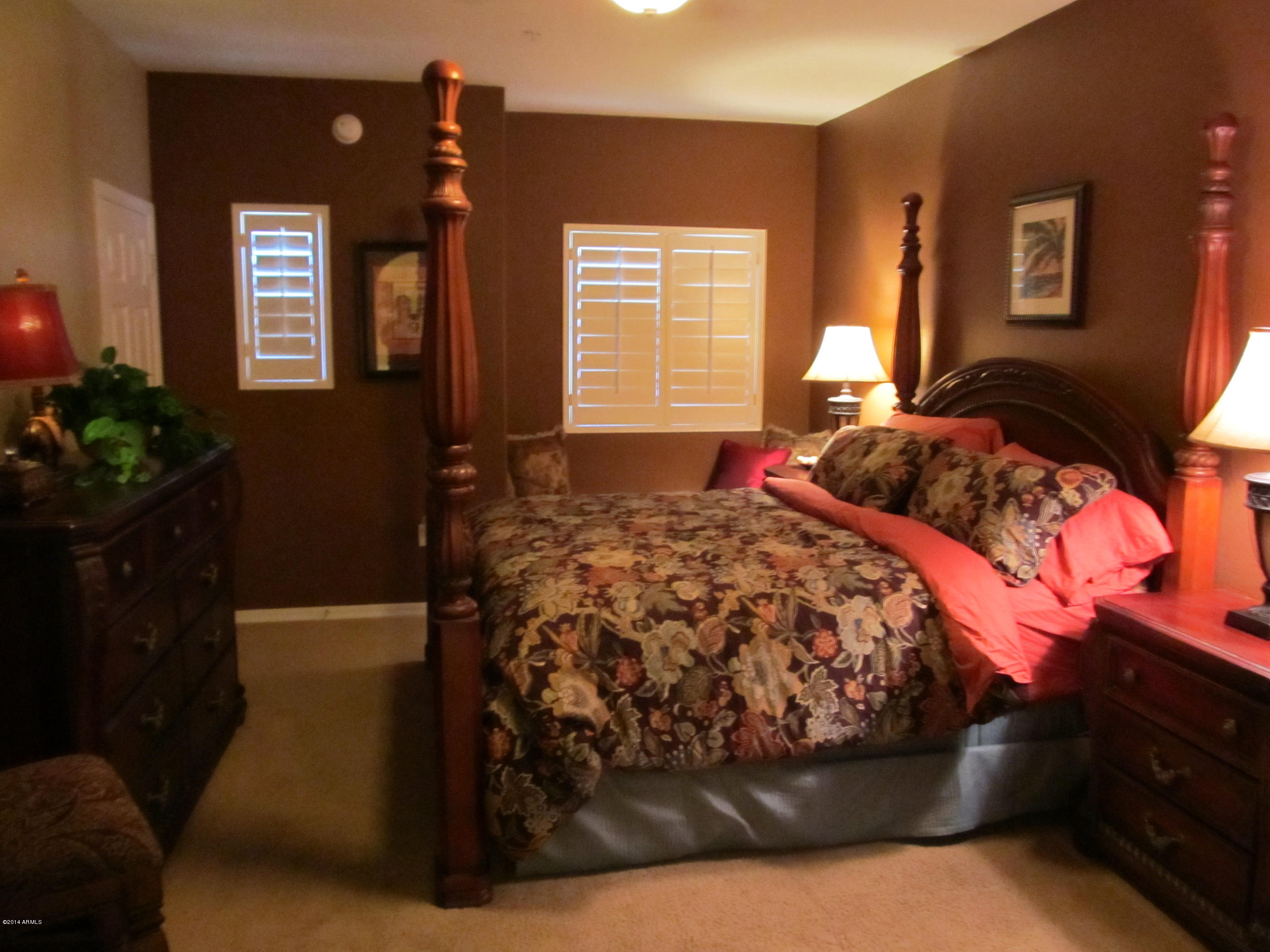 3935 East Rough Rider Road, Unit 1358 Phoenix, AZ 85050 - Photo 5 of 15 a bedroom with a bed and a potted plant