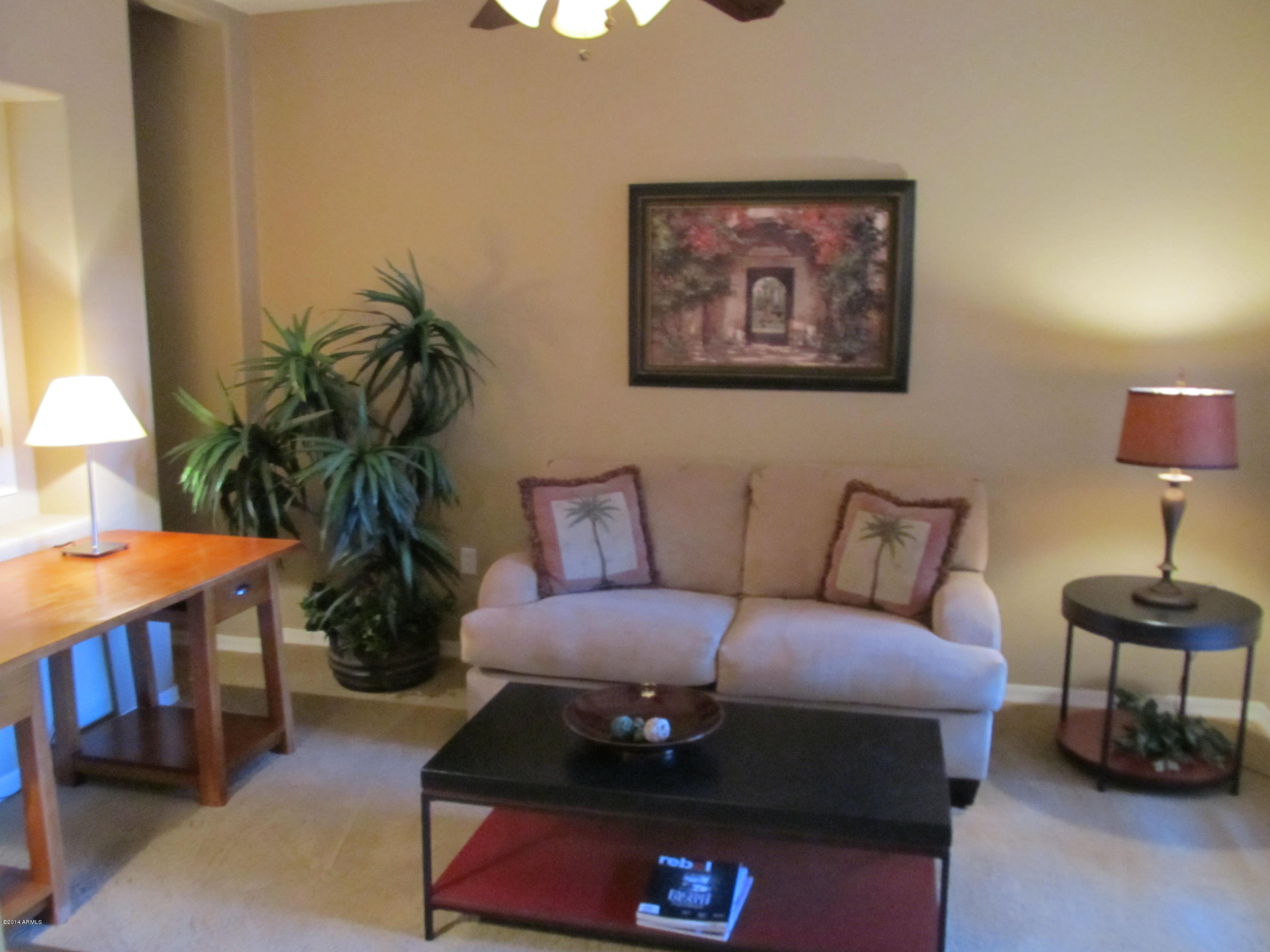 3935 East Rough Rider Road, Unit 1358 Phoenix, AZ 85050 - Photo 7 of 15 a living room with furniture and a potted plant