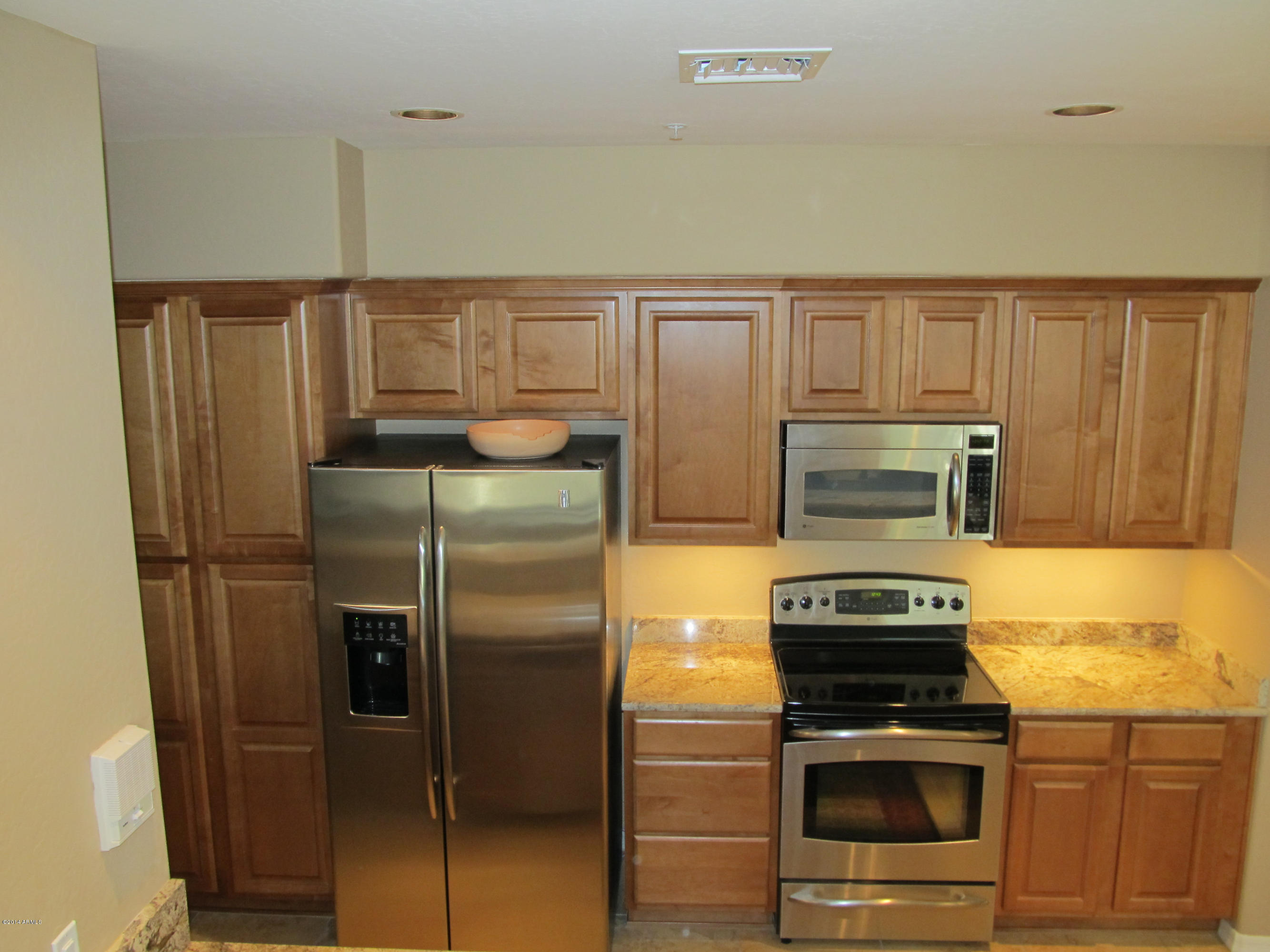 3935 East Rough Rider Road, Unit 1358 Phoenix, AZ 85050 - Photo 10 of 15 a kitchen with a refrigerator stove and microwave