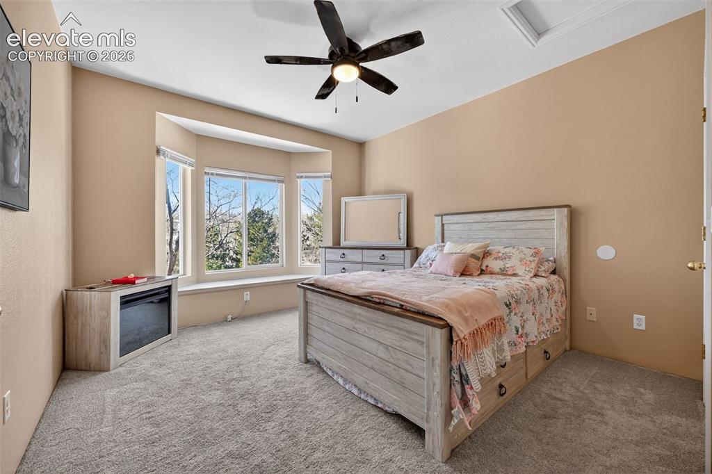 2141 Legacy Ridge View, Unit 109 Colorado Springs, CO 80910 - Photo 9 of 23 a bedroom with a bed and a large window