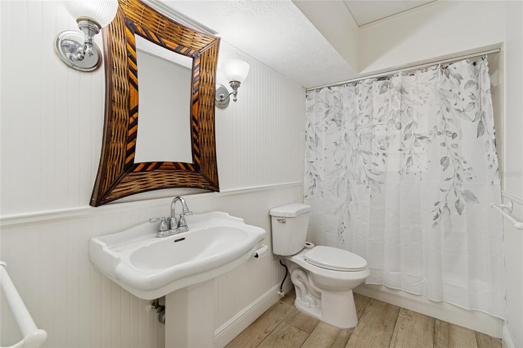 9628 Davis Road Tampa, FL 33637 - Photo 16 of 44 a bathroom with a toilet sink and mirror