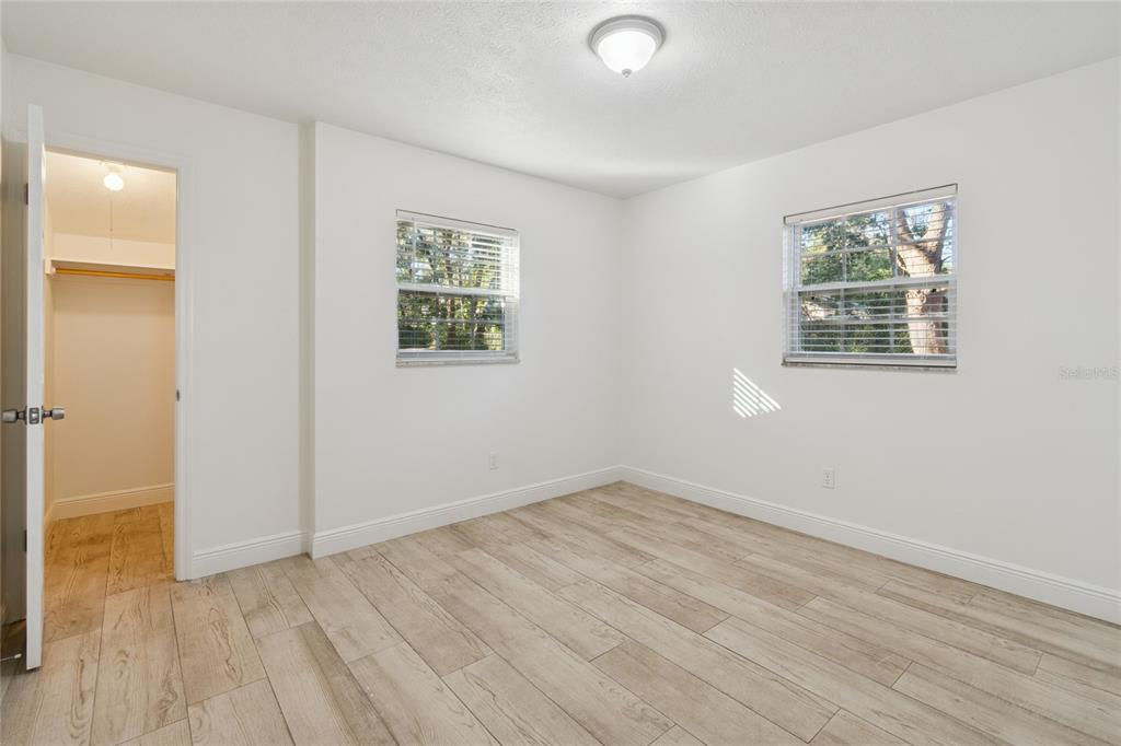 9628 Davis Road Tampa, FL 33637 - Photo 18 of 44 an empty room with wooden floor and windows