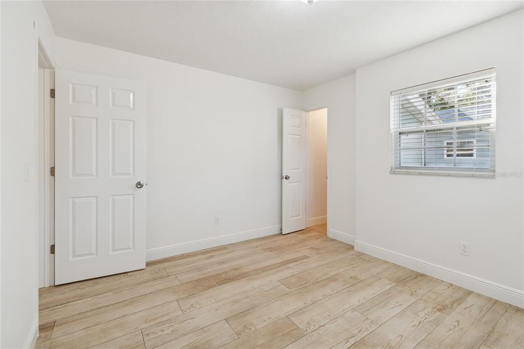 9628 Davis Road Tampa, FL 33637 - Photo 19 of 44 a view of an empty room with wooden floor and a window