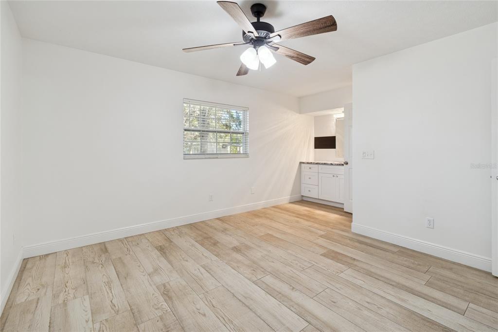 9628 Davis Road Tampa, FL 33637 - Photo 20 of 44 an empty room with wooden floor fan and windows