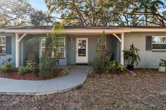 front view of a house with potted plants