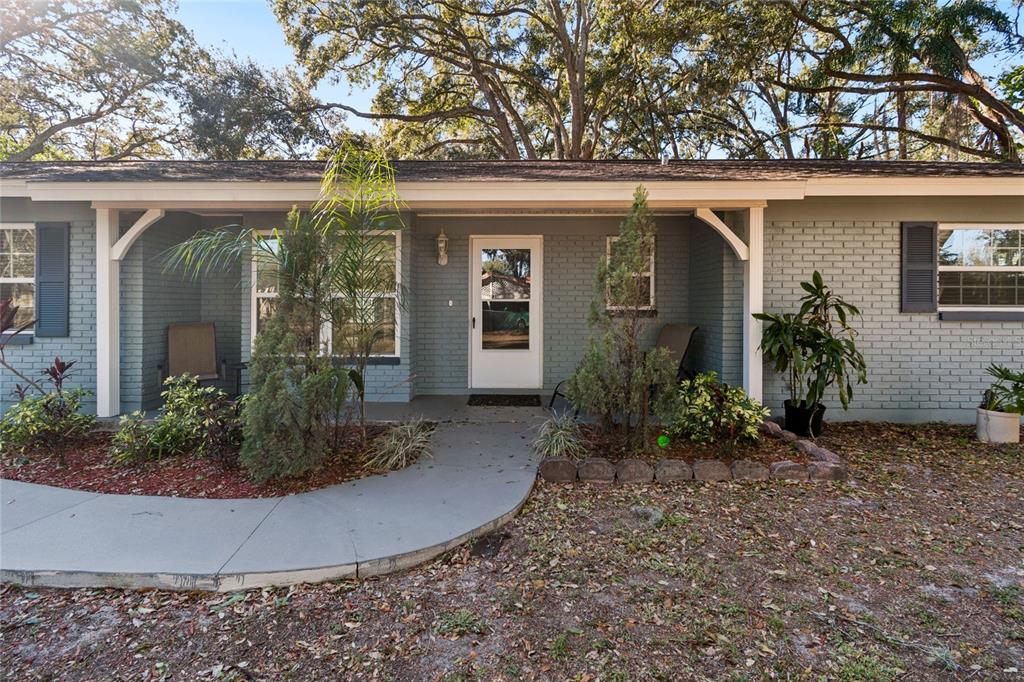 9628 Davis Road Tampa, FL 33637 - Photo 2 of 44 front view of a house with potted plants