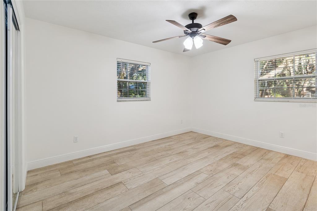 9628 Davis Road Tampa, FL 33637 - Photo 21 of 44 wooden floor in an empty room with a window