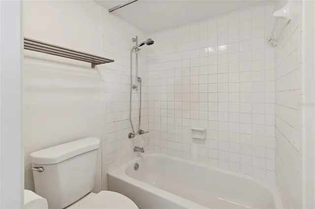 a white bath tub sitting next to a toilet