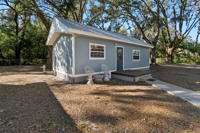a backyard of a house with barbeque oven