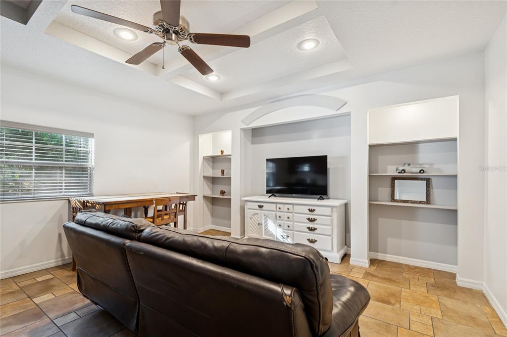 9628 Davis Road Tampa, FL 33637 - Photo 30 of 44 a living room with furniture and a flat screen tv