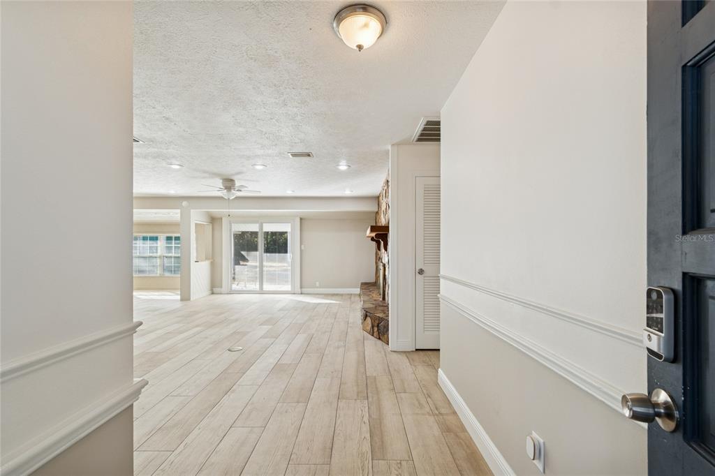 9628 Davis Road Tampa, FL 33637 - Photo 3 of 44 wooden floor in an empty room and a window