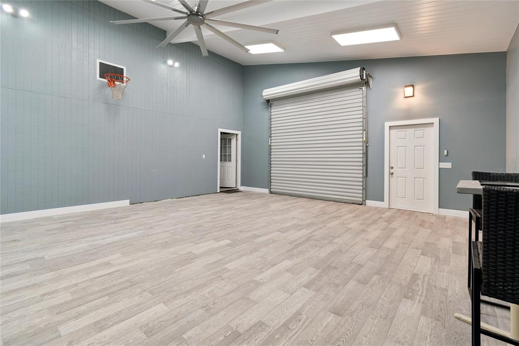9628 Davis Road Tampa, FL 33637 - Photo 37 of 44 a view of a livingroom with a hardwood floor and a ceiling fan