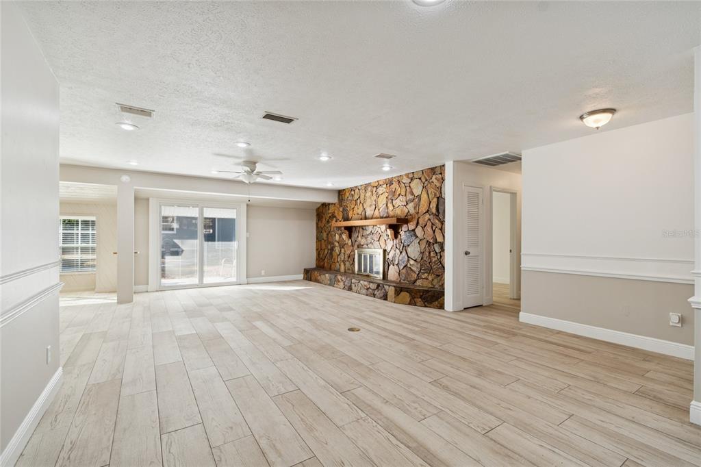 9628 Davis Road Tampa, FL 33637 - Photo 5 of 44 a big room with wooden floor and windows