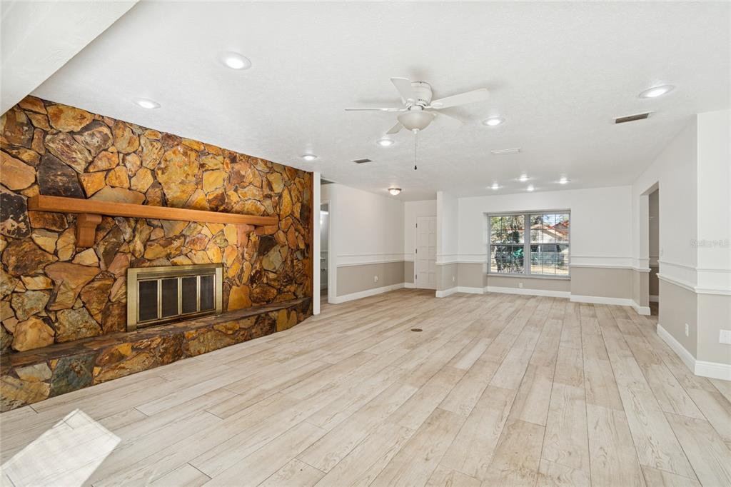 9628 Davis Road Tampa, FL 33637 - Photo 6 of 44 a view of an empty room with wooden floor