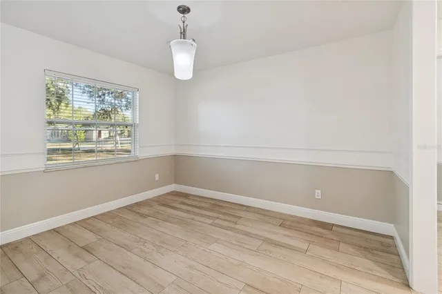 a view of room with window and wooden floor