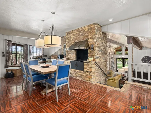a living room with furniture a fireplace and a chandelier