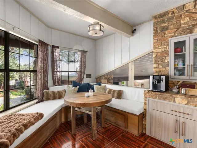 a dinning table and chairs in a kitchen