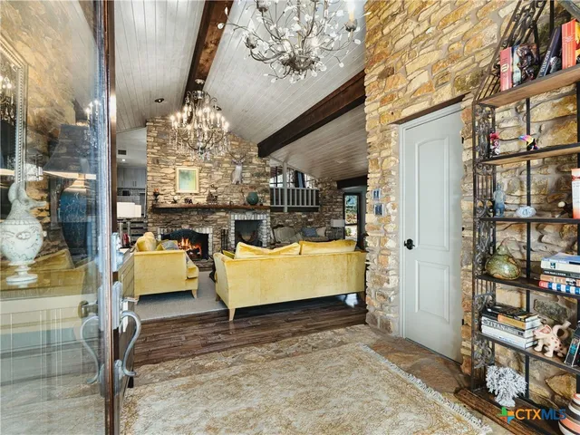 a view of living room with furniture and a chandelier