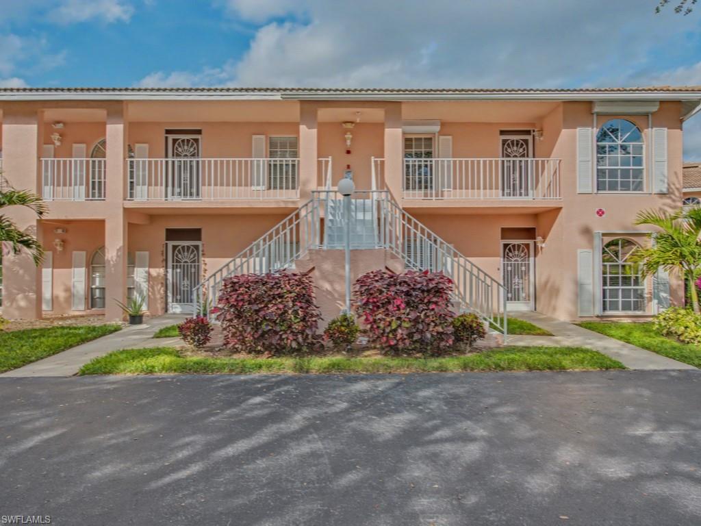 565 Augusta Boulevard, Unit 10 Naples, FL 34113 - Photo 1 of 16 a front view of a house with a yard and a garage