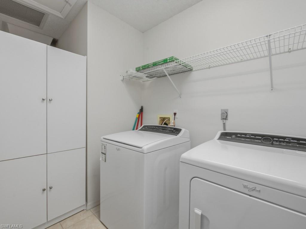 565 Augusta Boulevard, Unit 10 Naples, FL 34113 - Photo 14 of 16 a utility room with dryer and washer