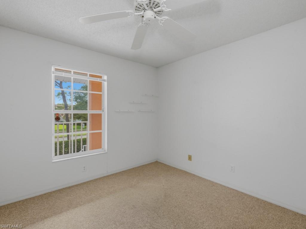 565 Augusta Boulevard, Unit 10 Naples, FL 34113 - Photo 7 of 16 an empty room with a window