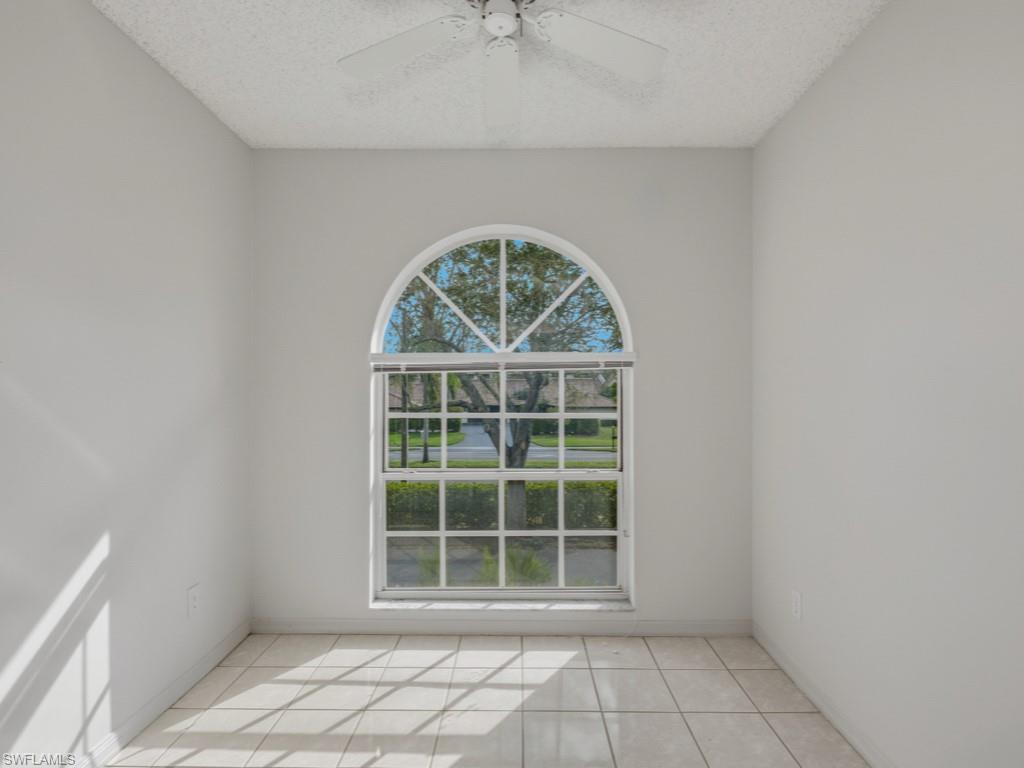 565 Augusta Boulevard, Unit 10 Naples, FL 34113 - Photo 8 of 16 an empty room with windows