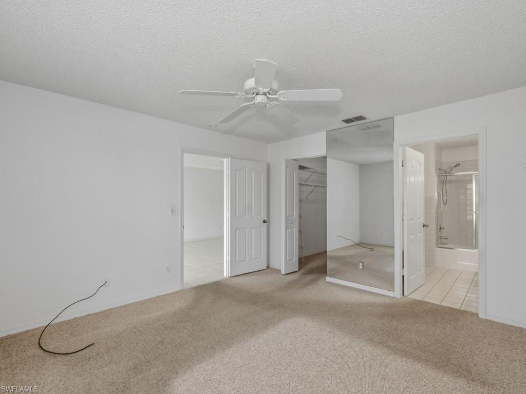565 Augusta Boulevard, Unit 10 Naples, FL 34113 - Photo 9 of 16 a view of a chandelier fan and entryway