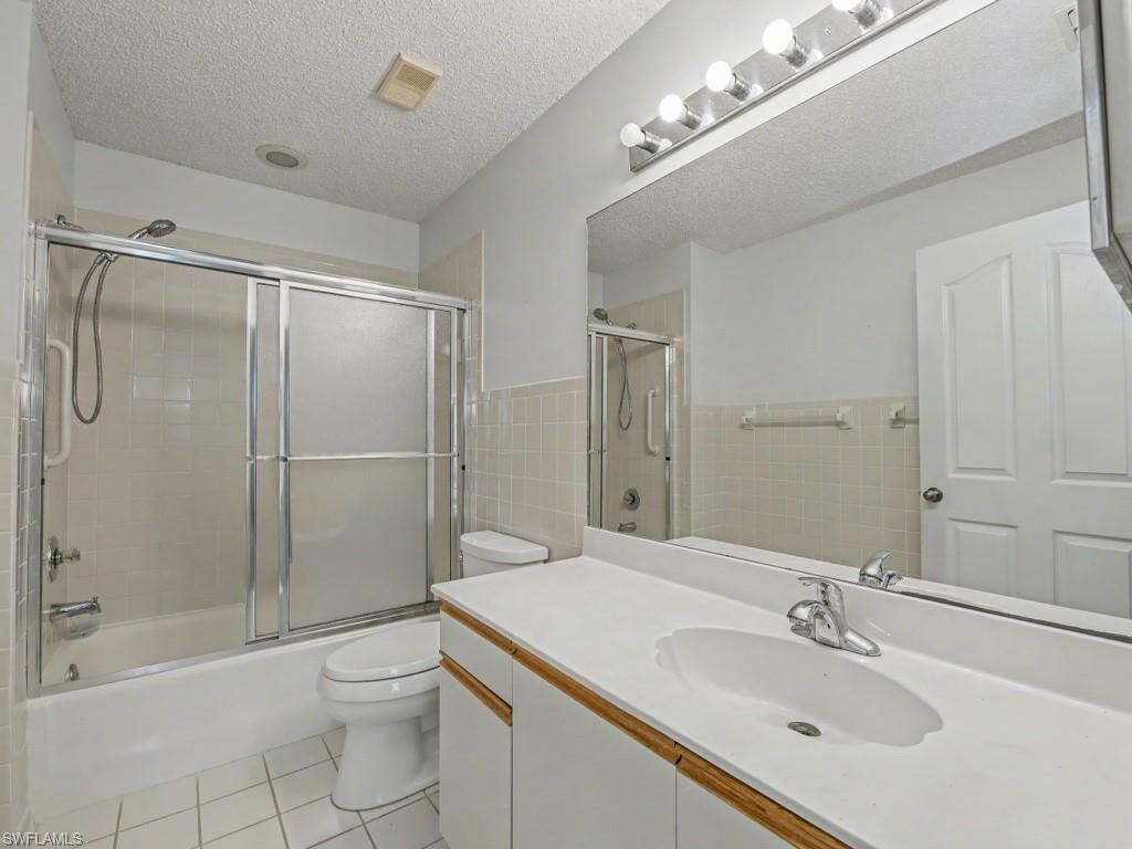 565 Augusta Boulevard, Unit 10 Naples, FL 34113 - Photo 10 of 16 a bathroom with a sink toilet and shower