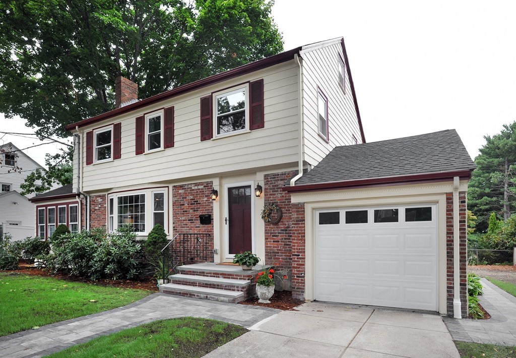 a front view of a house with a garden