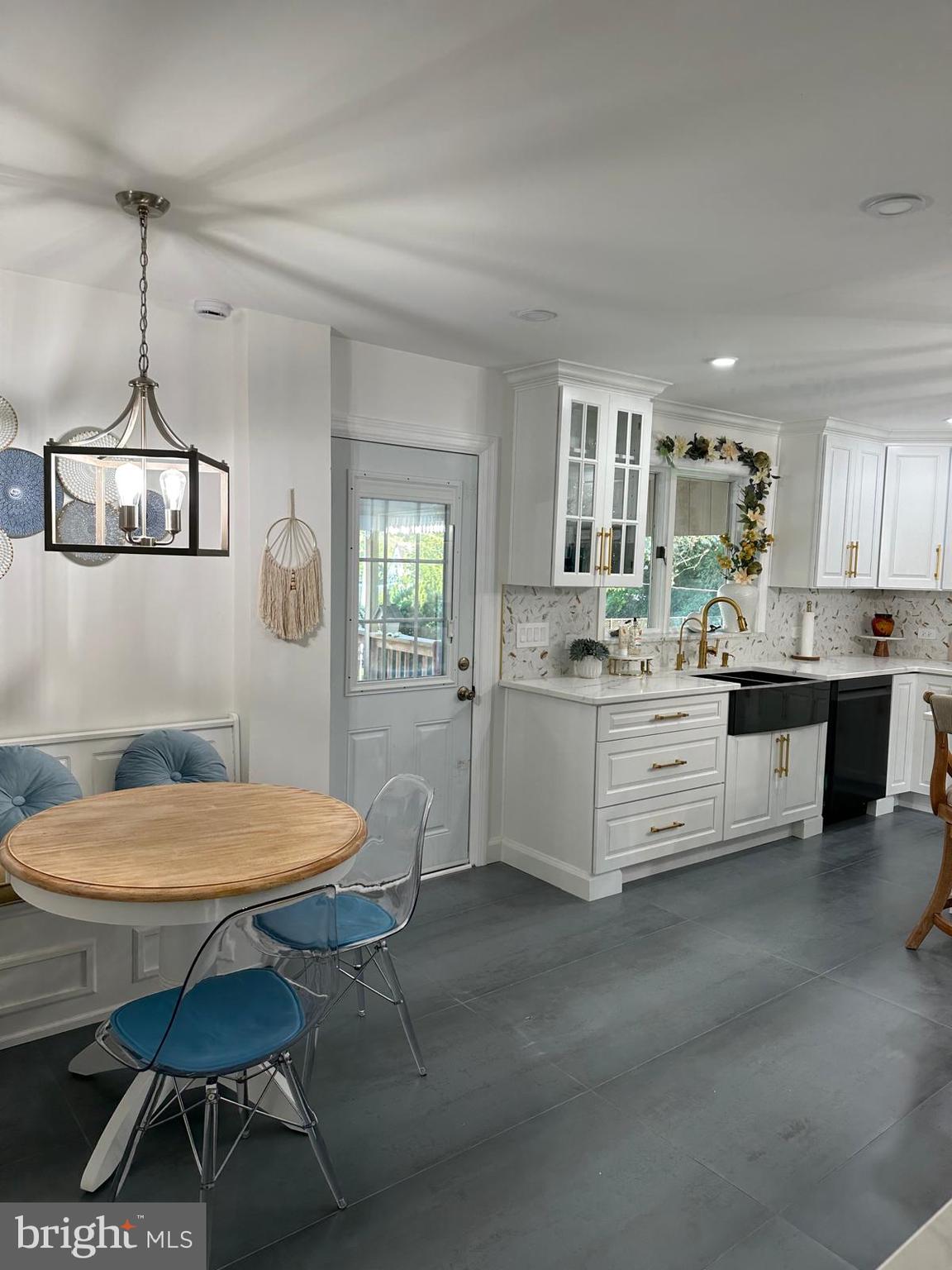 325 Wilson Road Blackwood, NJ 08012 - Photo 14 of 33 a kitchen with a dining table chairs cabinets and a window