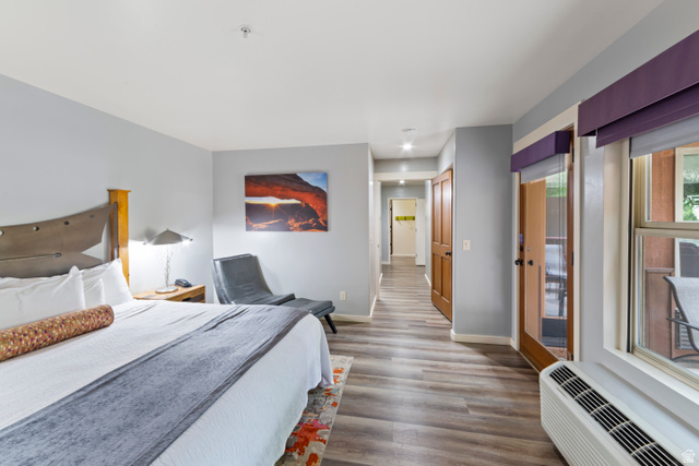 100 West 200 South, Unit 118 Moab, UT 84532 - Photo 23 of 39 Bedroom with access to exterior and dark wood-style floors