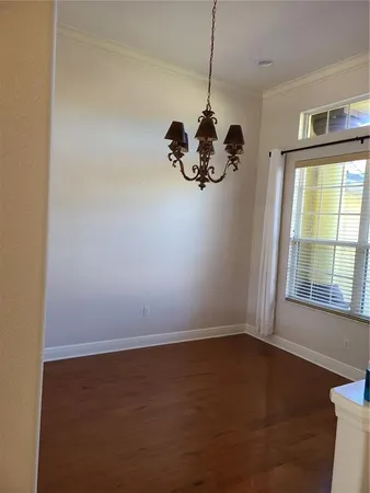 a living room with hard wood floors and a sink