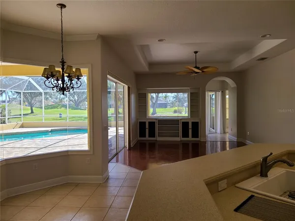 a view of a living room with hardwood floor and a large window