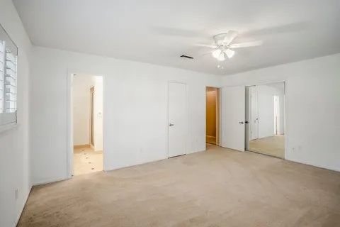 a view of an empty room with a ceiling fan