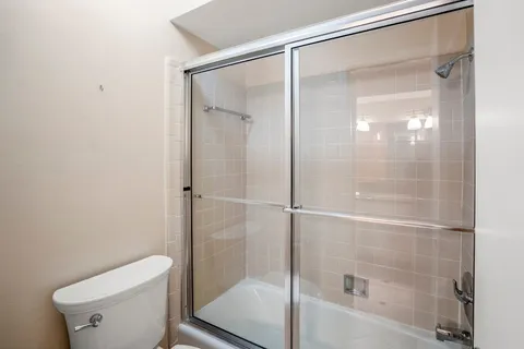 a bathroom with a glass shower door